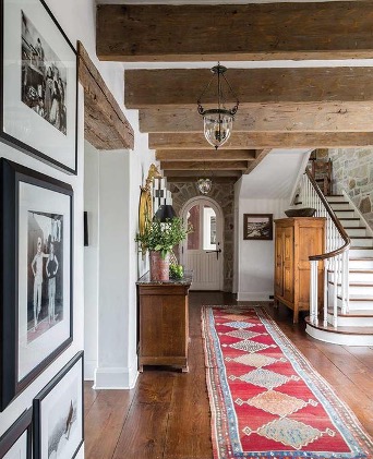 reclaimed beams and vintage area rug